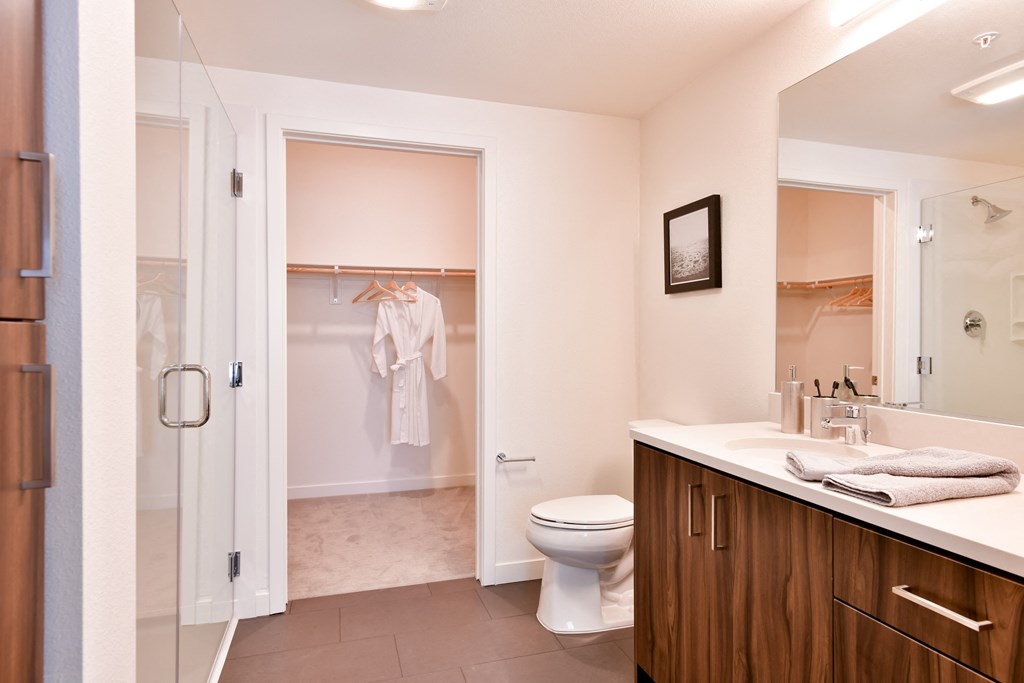 a bathroom with a toilet and a shower and a sink