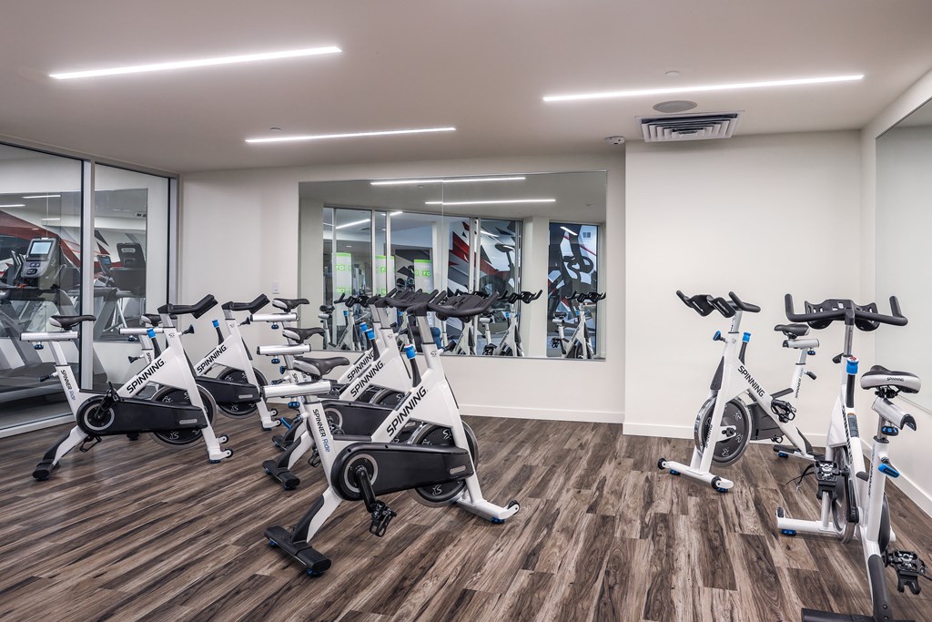 a gym with cardio bikes and other exercise equipment