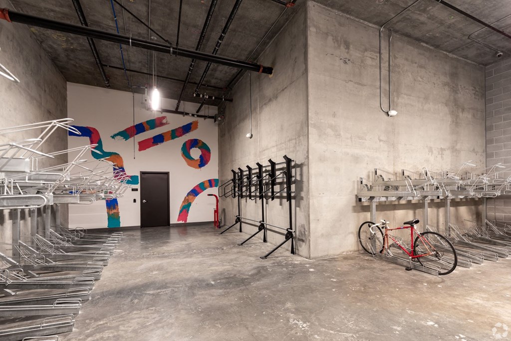 a room with a row of chairs and a bike in the corner