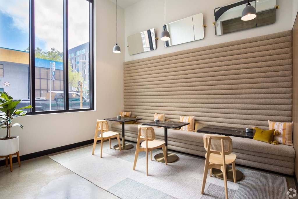 a dining area with tables and chairs and a large window