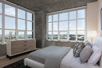 Furnished bedroom with wide open windows with views