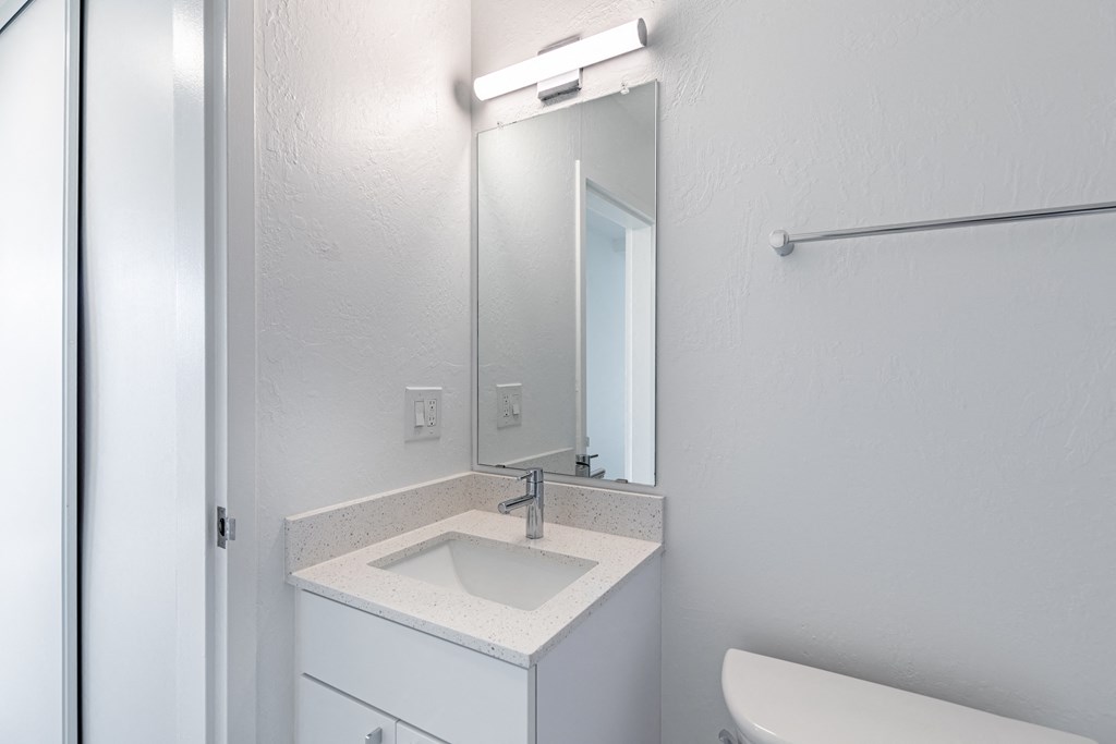 an empty bathroom with a sink and a mirror at Avenue Two Apartments, Redwood City  , CA 94063
