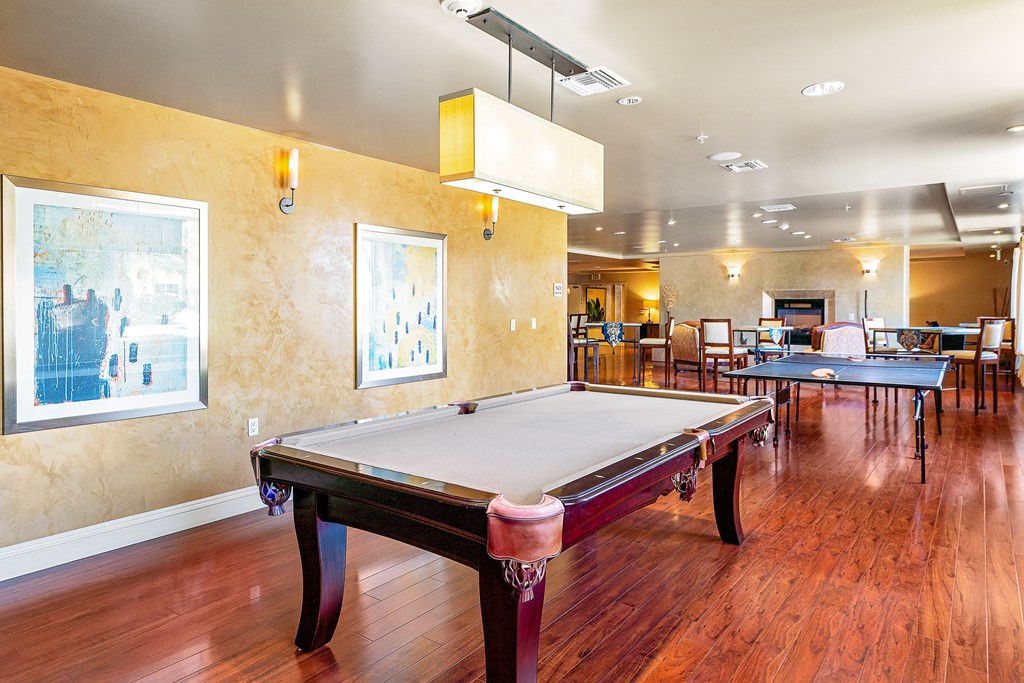 a game room with a pool table and ping pong