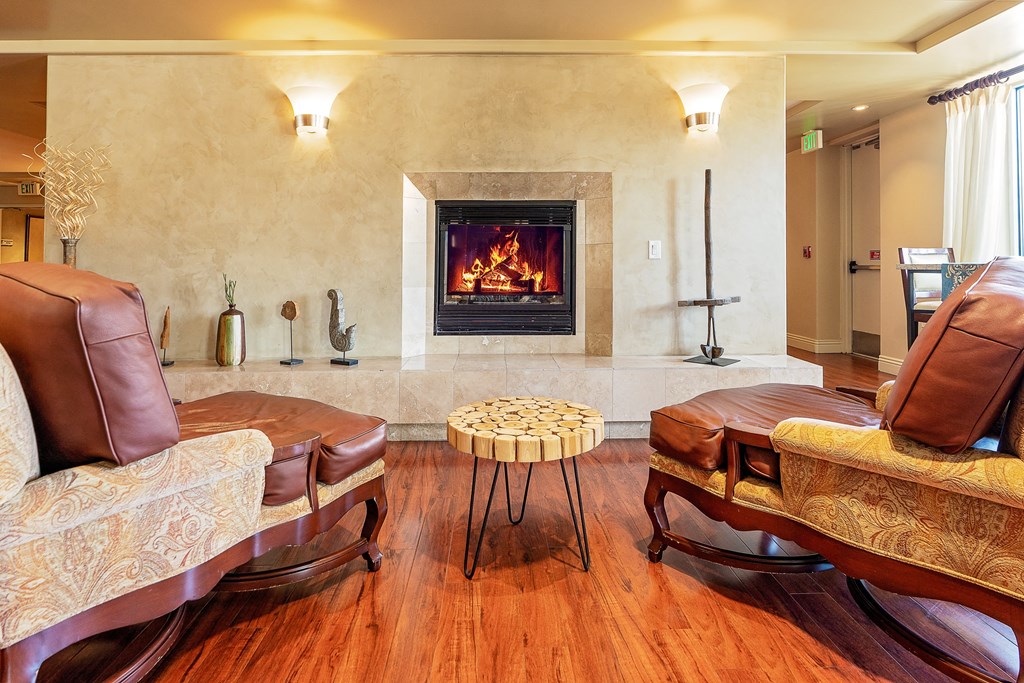 Clubroom with a fireplace and leather furniture