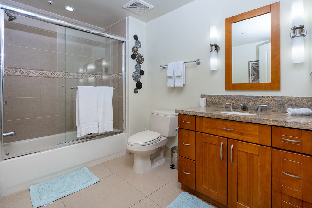 a bathroom with a large vanity and a walk in shower