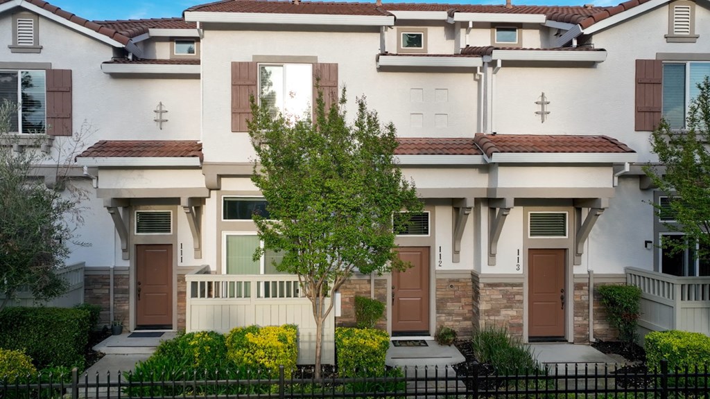 A white house with brown doors and windows.