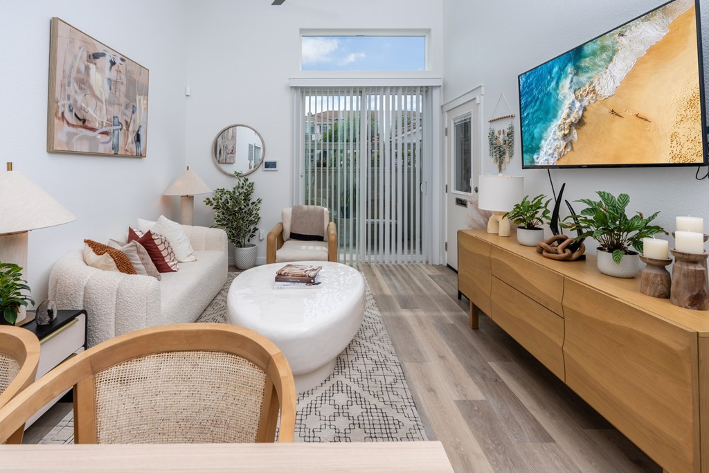 Pet-Friendly Apartments in Roseville, CA - Adora - Living Room with Hardwood-Style Flooring, Access to Patio/Balcony, and a Ceiling Fan