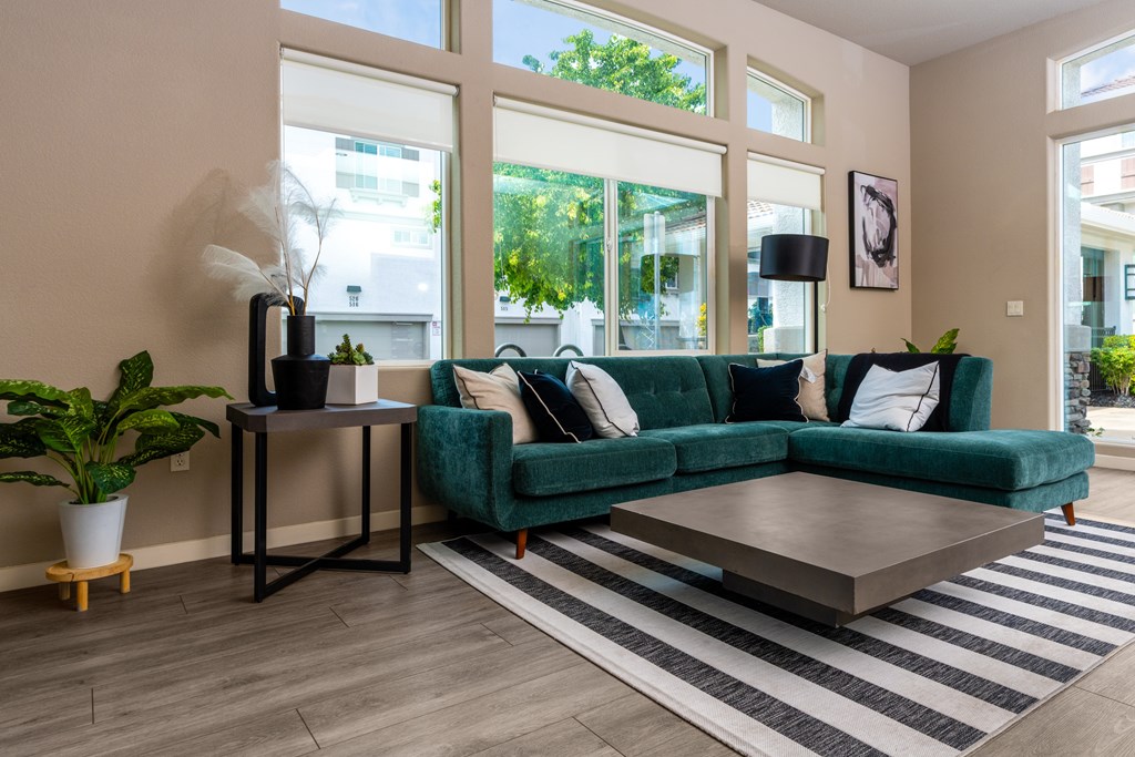 Clubhouse with a green couch and a coffee table.