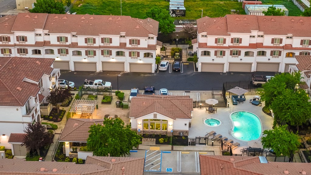A large building with a pool in front of it.