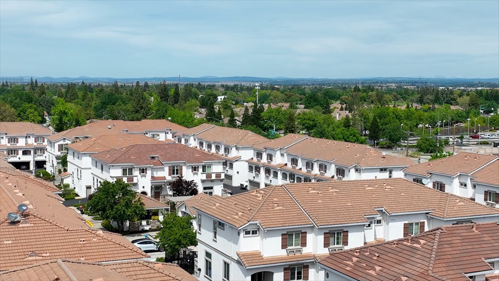 A view of a residential area with houses and trees.