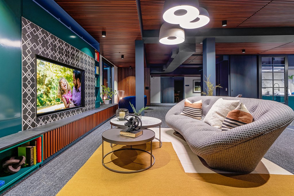 a living room filled with furniture and a flat screen tv