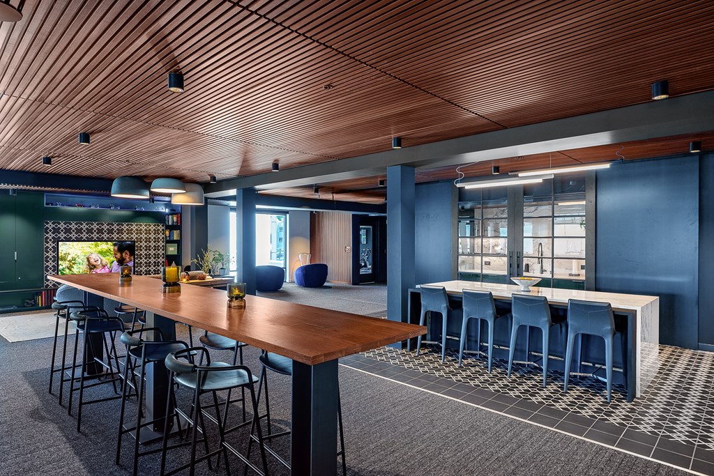 a large table with chairs and a bar in the middle of the room