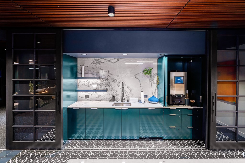 a kitchen with blue cabinets and a white marble countertop