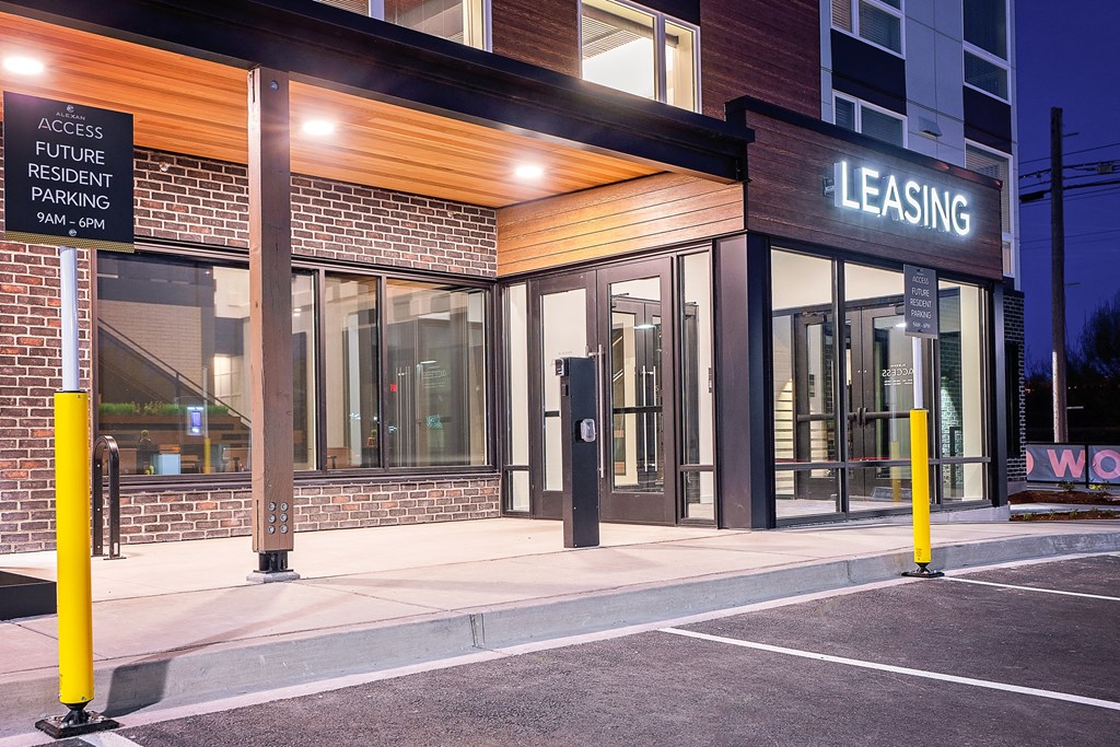 a building with a leasing sign in front of it