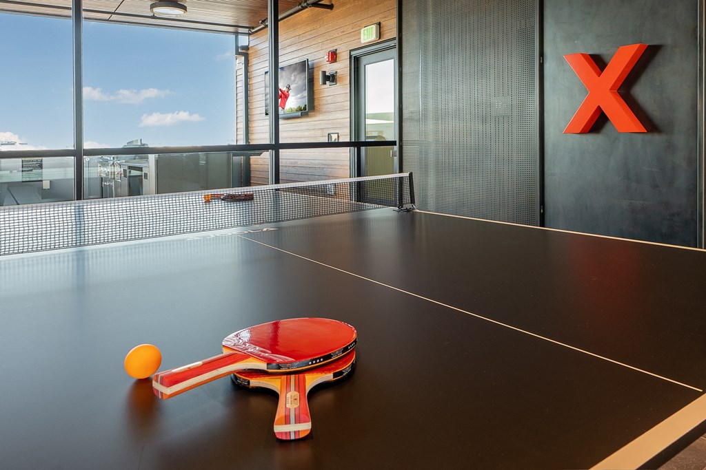a table tennis racket and ball on a ping pong table