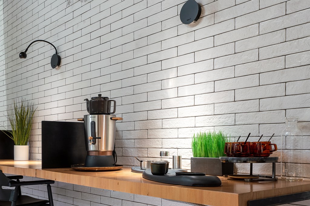 a kitchen counter with a coffee maker and a coffee pot on top of it
