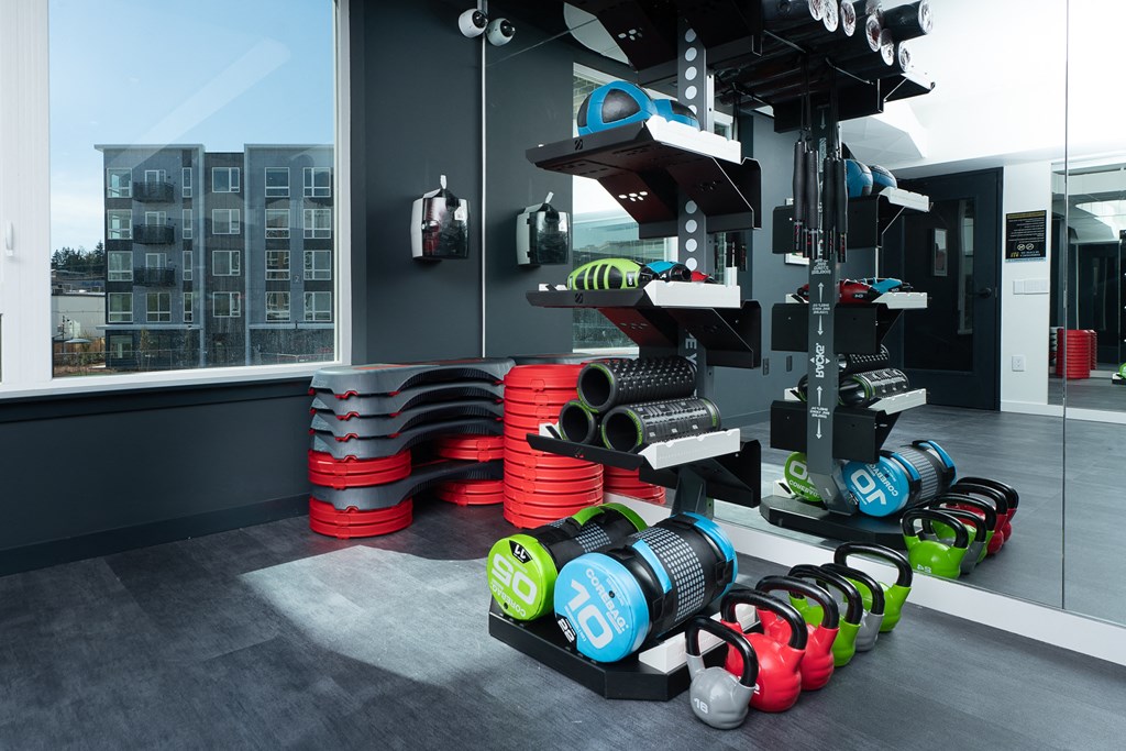 a photo of a fitness room with a variety of weights
