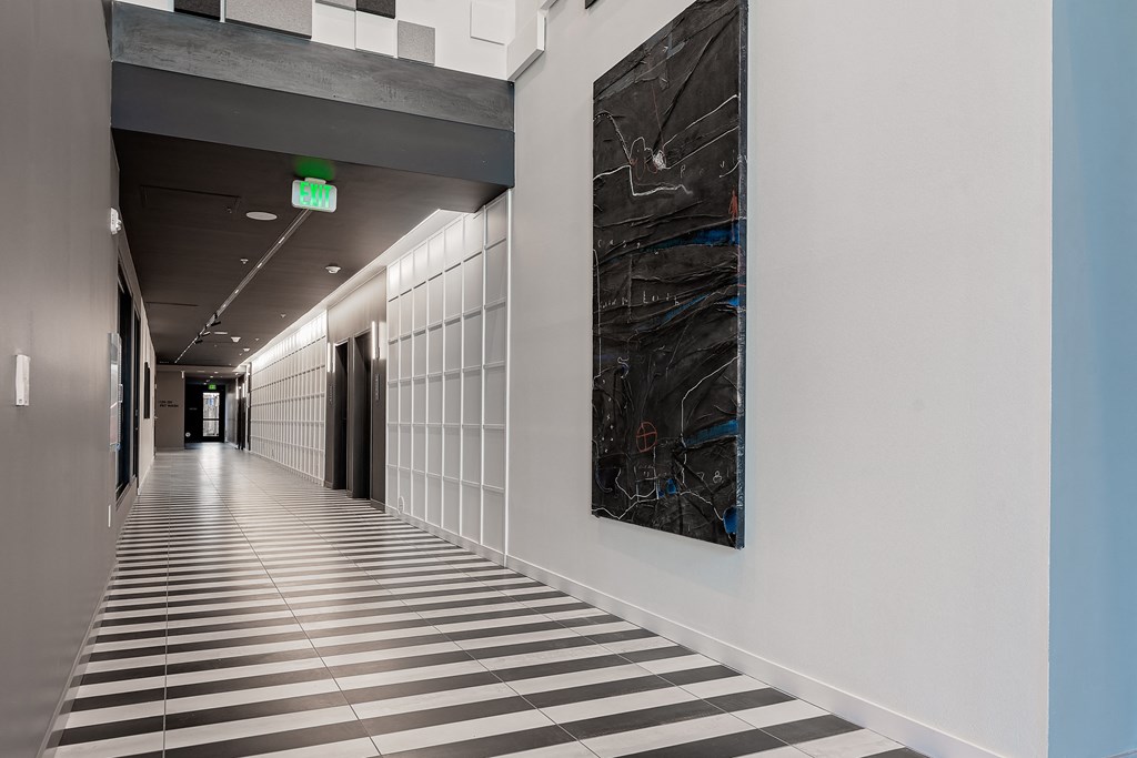 a hallway with a large black and white painting on the wall