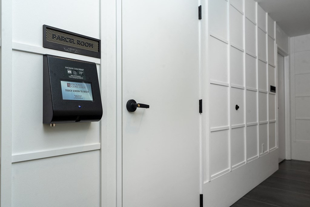 a room with a white door and a black mailbox on the wall