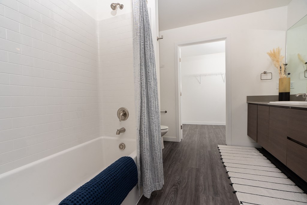 a bathroom with a bathtub and shower in a 555 waverly unit