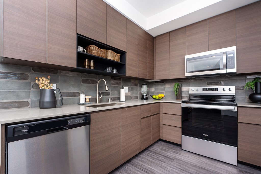 a kitchen with wooden cabinets and stainless steel appliances