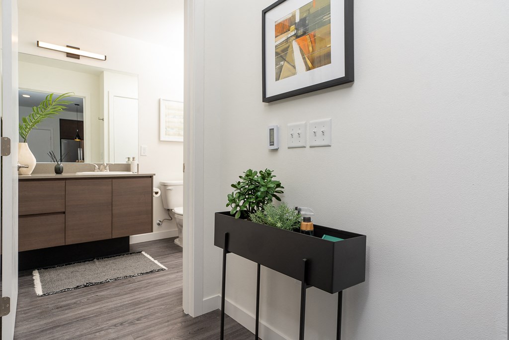 a bedroom with a medium sized bed and a mirror on the wall