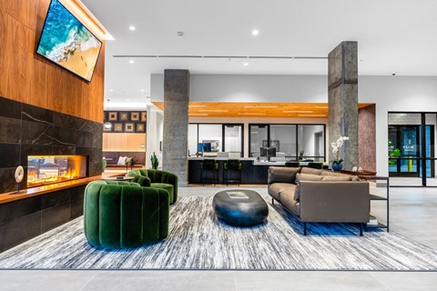 Clubroom with a fireplace and a large green ottoman.