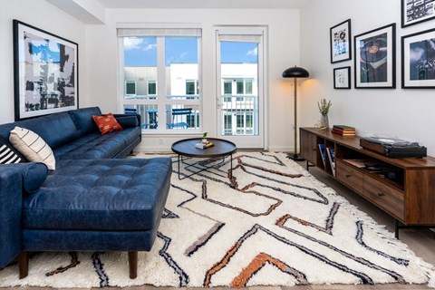 Living room with sofa, coffee table and balcony