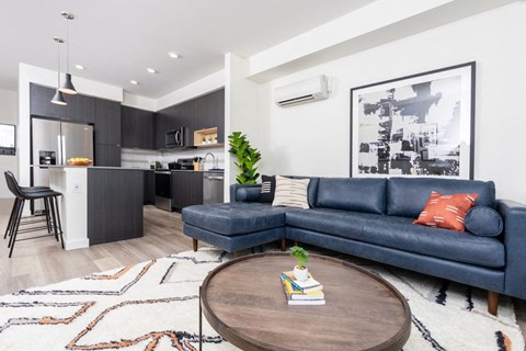Kitchen with island next to living room with sofa