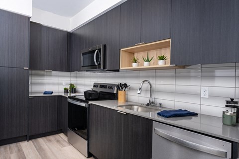 Kitchen with tiled backsplash and stainless steel appliances