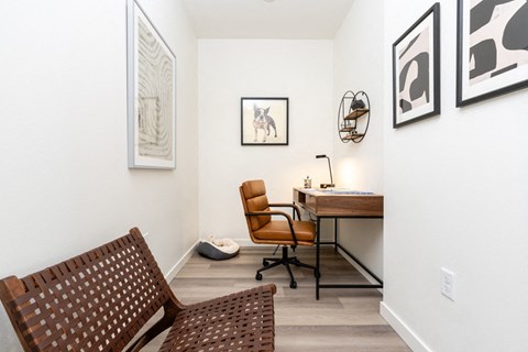 A brown chair sits in front of a desk with a computer on it.