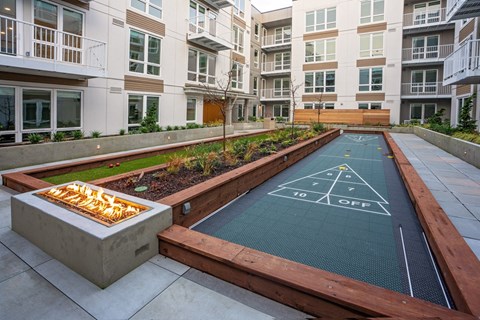 A miniature golf course is located in the courtyard of a residential building.