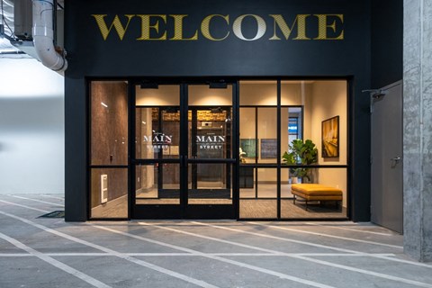 Alexan Main Street exterior with Welcome signage