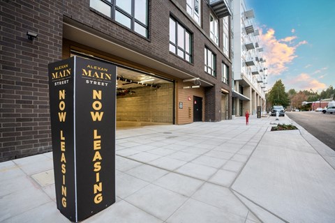 Alexan Main Street exterior with Now Leasing signage