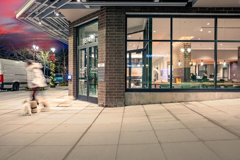 Person walking pass Alexan Main Street exterior