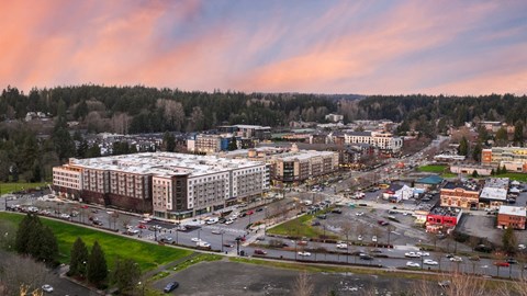 A large building complex with a parking lot in front of it.