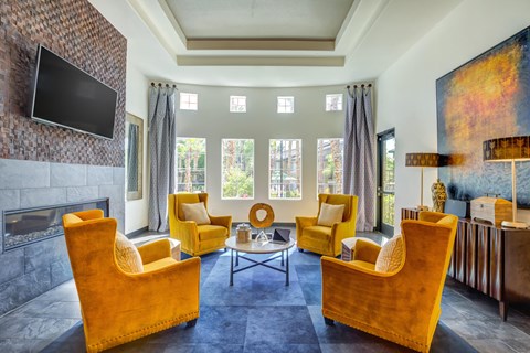A living room with a fireplace and a television on the wall.