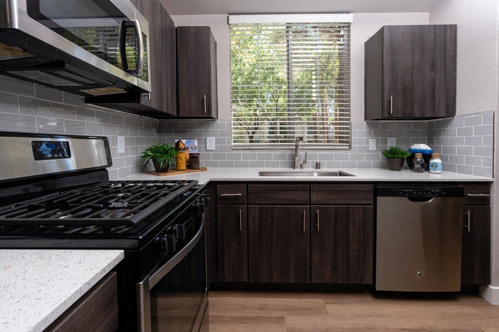 a kitchen with stainless steel appliances and wooden cabinets