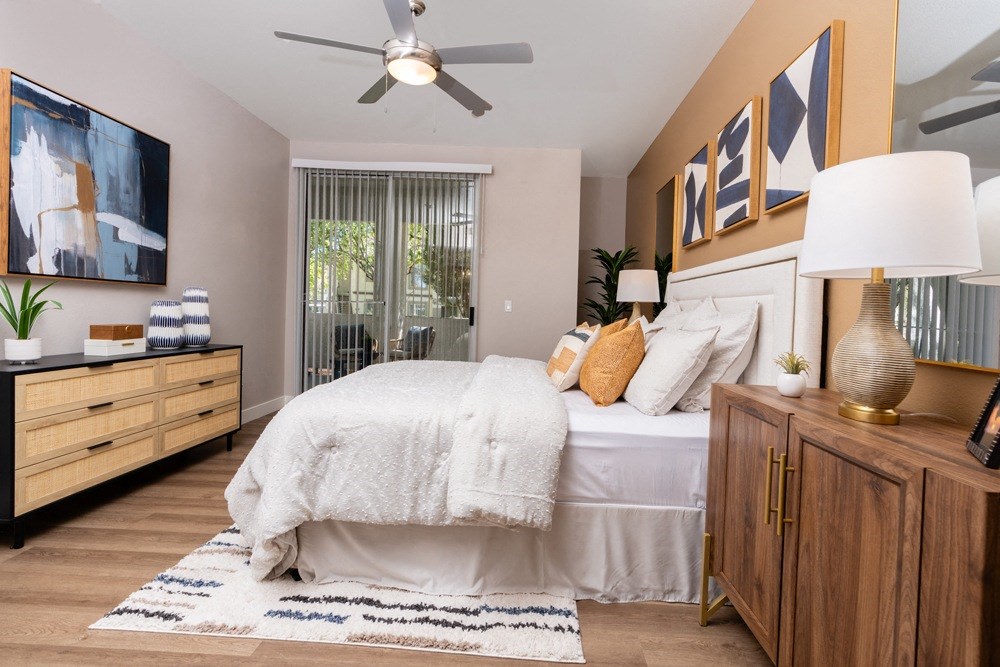a bedroom with a bed and a ceiling fan