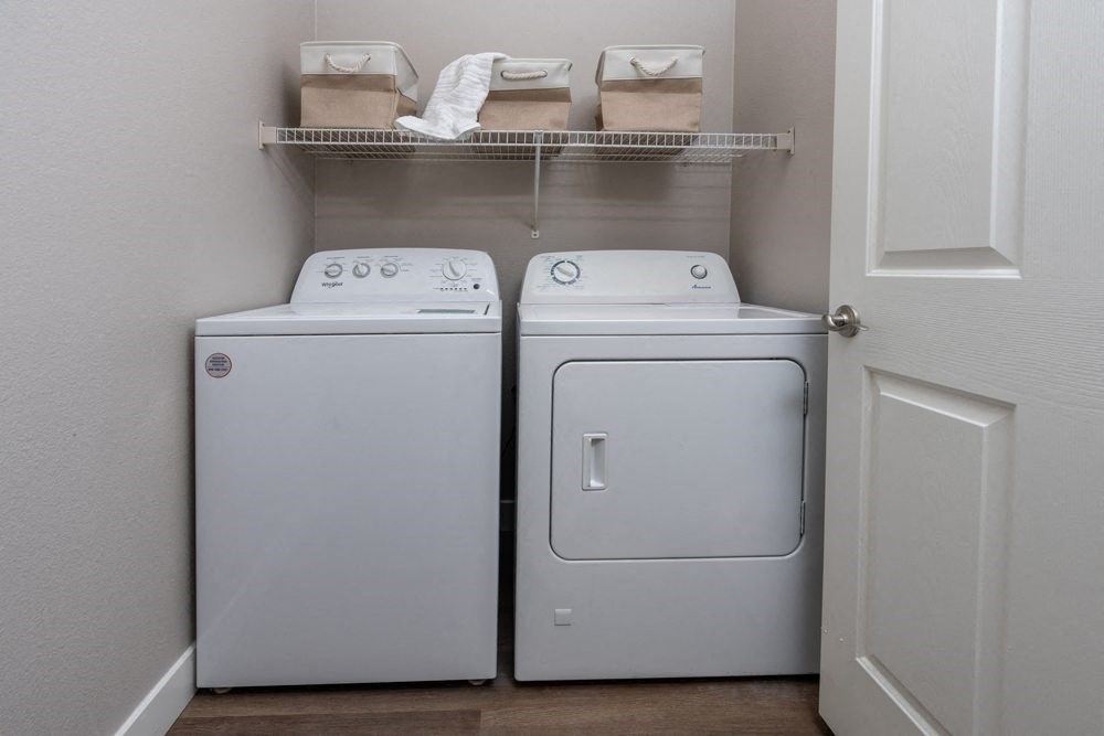 a washer and dryer in a laundry room with a door
