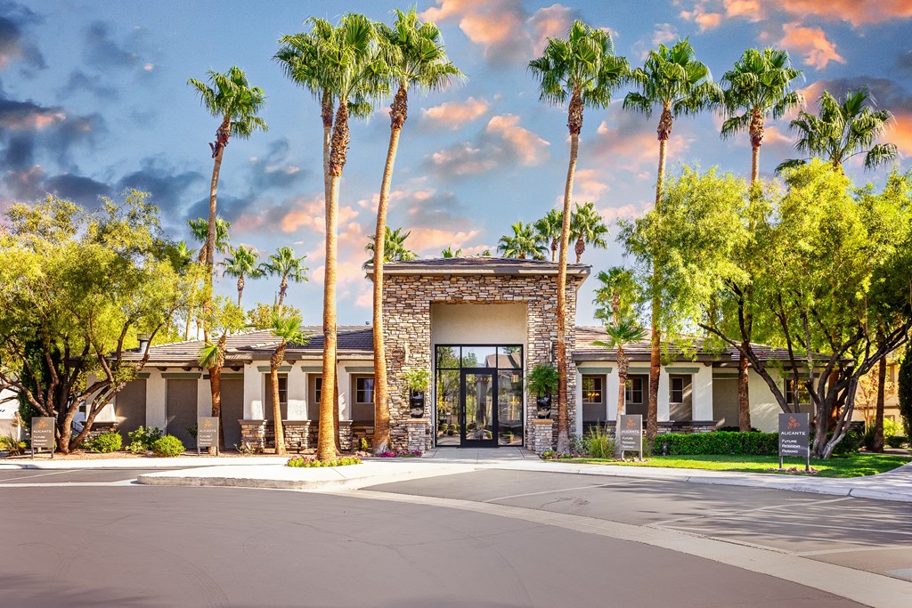 89147 Apartments for Rent Spring Valley NV - Alicante - Leasing Office Exterior Surrounded by Palm Tree and Landscaped Ground, Available Parking in Front