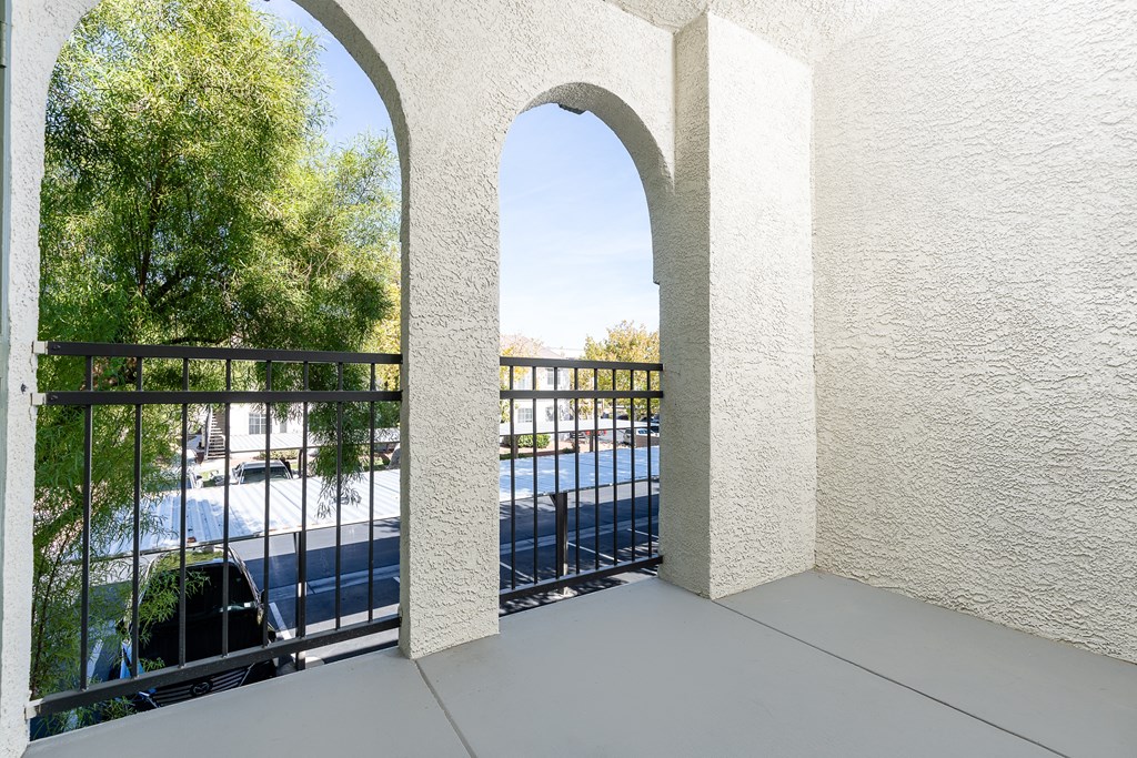 a balcony with a view of a pool and trees