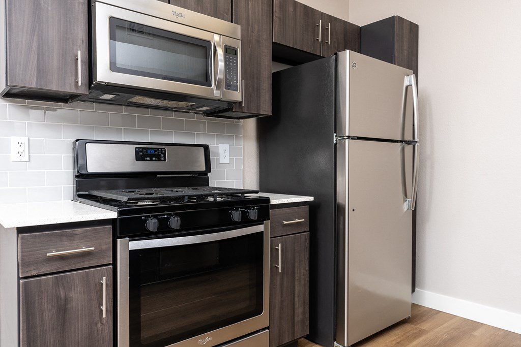 a kitchen with stainless steel appliances and a refrigerator