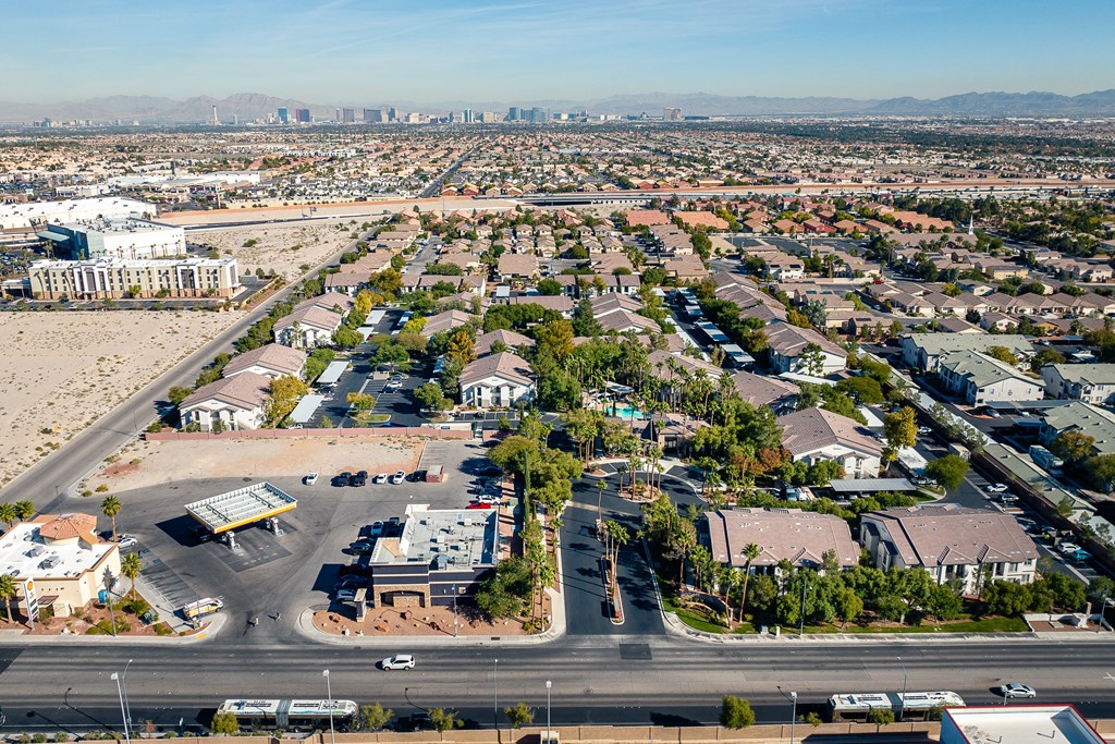 an aerial view of a neighborhood of houses and cars on a road