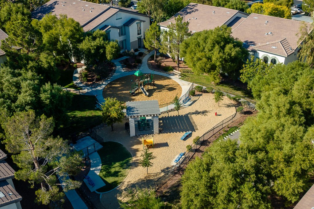 an aerial view of a playground in a neighborhood with houses