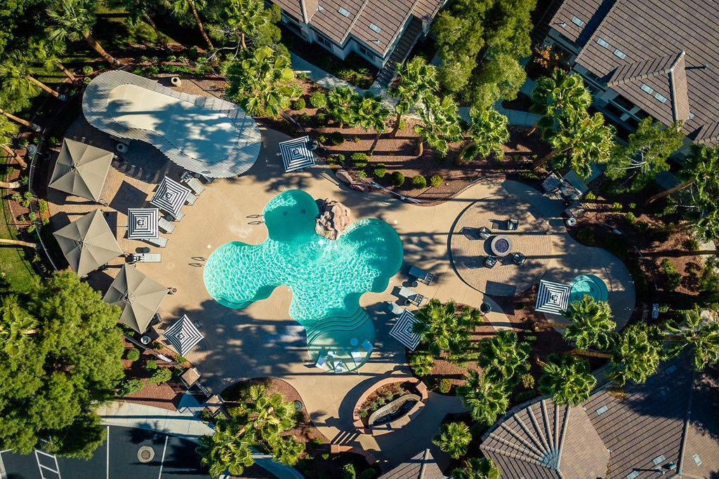 an aerial view of a swimming pool with blue water