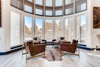 Denver Apartments for Rent - Allure - Clubhouse with Lots of Windows, Four Leather Chairs, and Bear Skin Rug - Photo Gallery 2