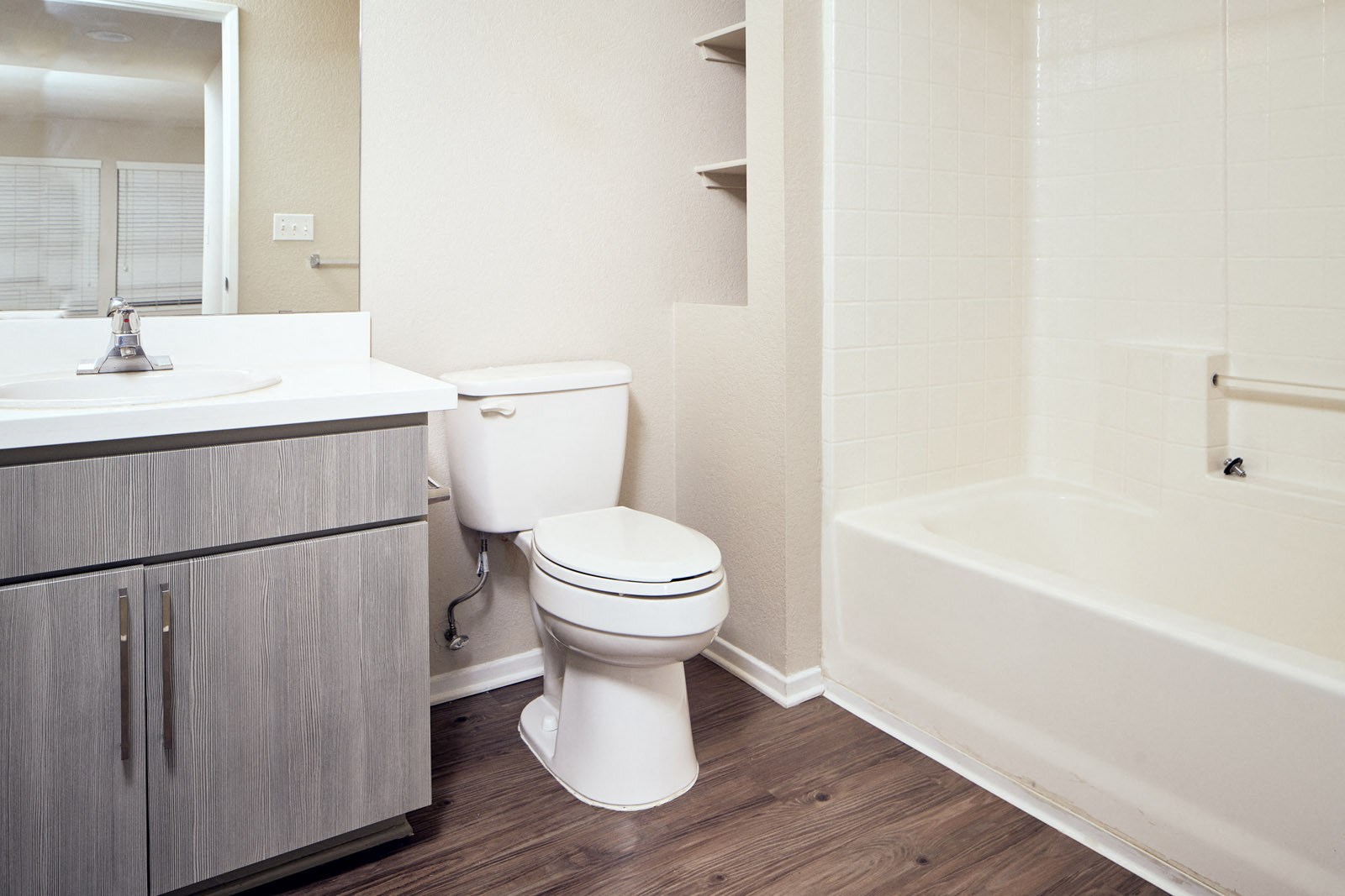 Apartments in Escondido - Alta Vista - Bathroom with Grey Cabinets and Wood-Style Flooring