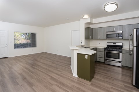 A kitchen with a white island and stainless steel appliances.