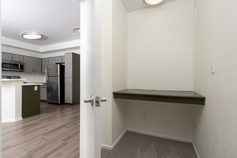 A kitchen with a refrigerator, microwave, and oven.